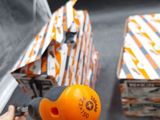 a person that is holding an orange object in their hand