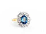 a close up of a blue and white diamond ring