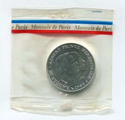 a small coin in a plastic bag on a white surface
