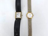 a couple of watches sitting next to each other on a table