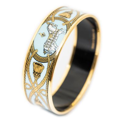 a close up of a ring with a gold and blue design on it