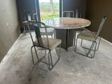 a table and chairs in a room with a large window