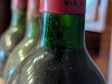 several bottles of wine are lined up on a table