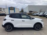 a white suv parked in a parking lot next to a building