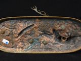 an image of a bronze sculpture of a fish on a rock