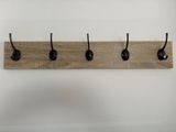 a close up of a wooden coat rack with four hooks