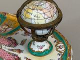 a plate with a globe on top of it
