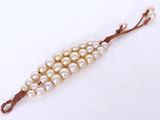 a close up of a string of pearls on a white surface