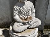 a statue of a buddha sitting on top of a pedestal