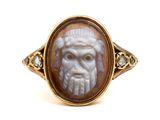 an image of a ring with a man ' s face carved into it