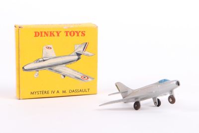 a toy airplane sitting next to a box of dinky toys