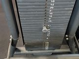 a close up of a gym equipment with a red seat