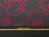 a picture of a black and pink purse with flowers on it