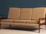 an image of a brown couch sitting on top of a carpeted floor