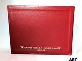 a red wallet sitting on a table with a white background