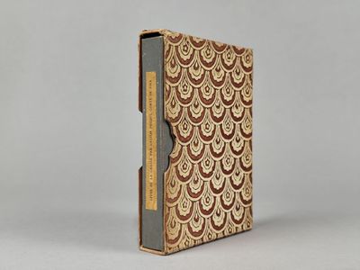 un livre marron et blanc posé sur une table blanche