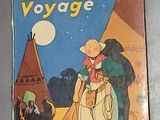 La couverture du livre *Becassine voyage* est posée sur une table.
