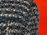 a close up of a black and gold sweater on a mannequin mannequin mannequin mannequin mannequin mannequin mannequin