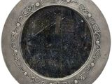 a silver plate with a clock on it on a white background