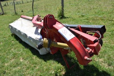 a red tractor that is sitting in the grass