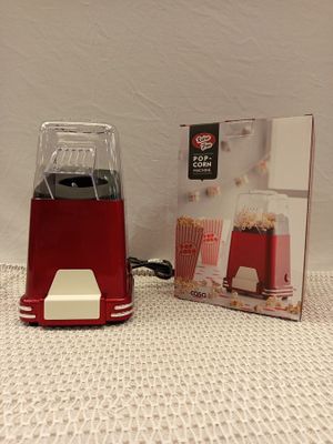 a red blender sitting next to a box of popcorn