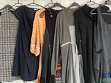 a lot of clothes hanging on a rack in a room