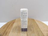 an image of a tube of cream sitting on a wooden table