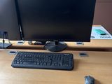 a computer desk with two monitors and a keyboard