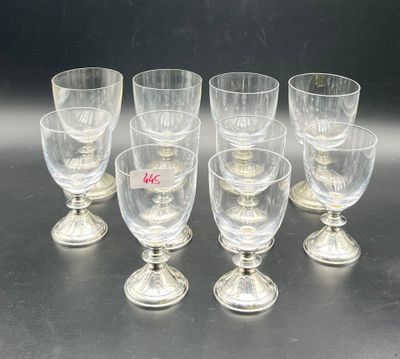 six clear wine glasses sitting on top of a table next to each other
