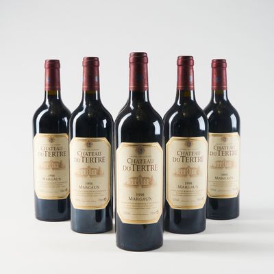 four bottles of red wine are lined up on a white surface