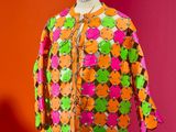 an orange and green jacket on a mannequin mannequin mannequin mannequin mannequin mannequin mannequin mannequin mann