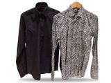 two men ' s shirts hanging on a clothes rack on a white background