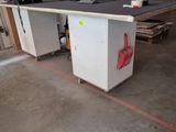 a picture of a workbench in a warehouse with a lot of work on it