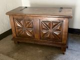 a wooden chest sitting on the floor in the corner of a room