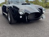 an image of a black sports car parked in a parking lot