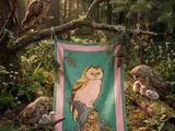 an image of a blanket hanging on a tree branch in the woods