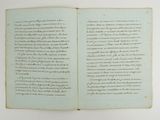 an open book with writing on it sitting on top of a table
