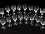 several empty wine glasses are arranged in a circle on a black surface