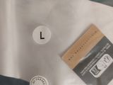 a label on the back of a shirt that has a barcode on it