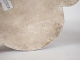 a white plate with a brown bear head on it