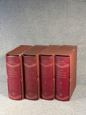 four red books are stacked on top of each other on a table