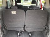 two seats in the back of a van with the doors open