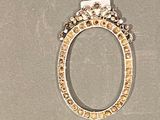 a picture of a gold and diamond ring on a gray surface