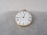 une horloge blanche dont le cadran est orné de chiffres romains