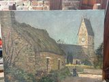 a painting of a church on a easel in front of a brick wall