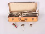 an old trumpet in a suitcase with other items around it