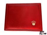 a close up of a red wallet with a crown on it