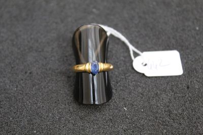 a ring with a blue stone on it on a table