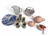 many different types of teapots and cups on the table
