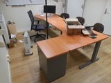 a desk with a monitor and a chair in the room